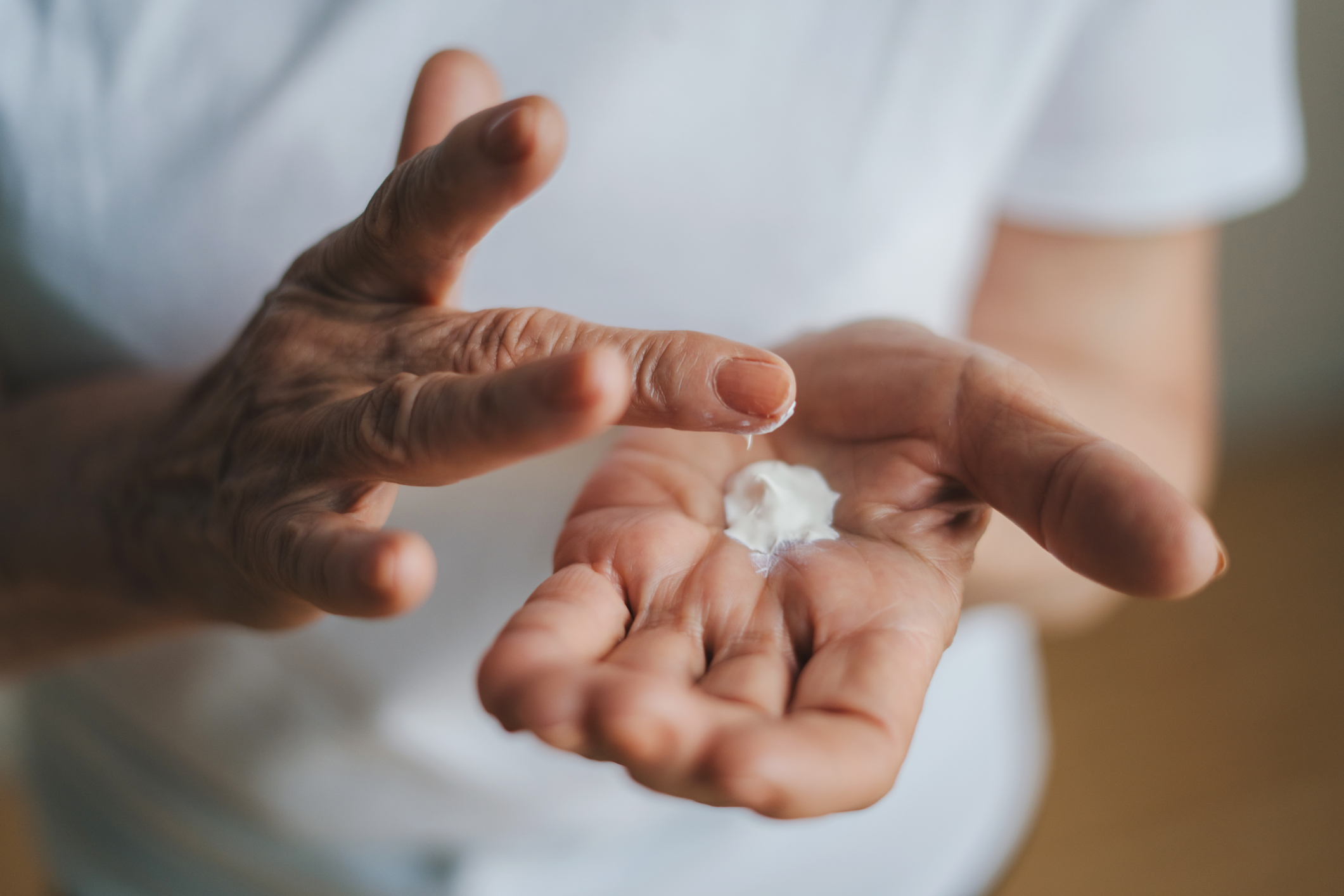 Mature woman applying hand cream
