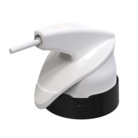 A Close up of Runway, a white Dual Trigger Aerosol device with an extention attached at the front, resting on a black, circular base against a plain white background.